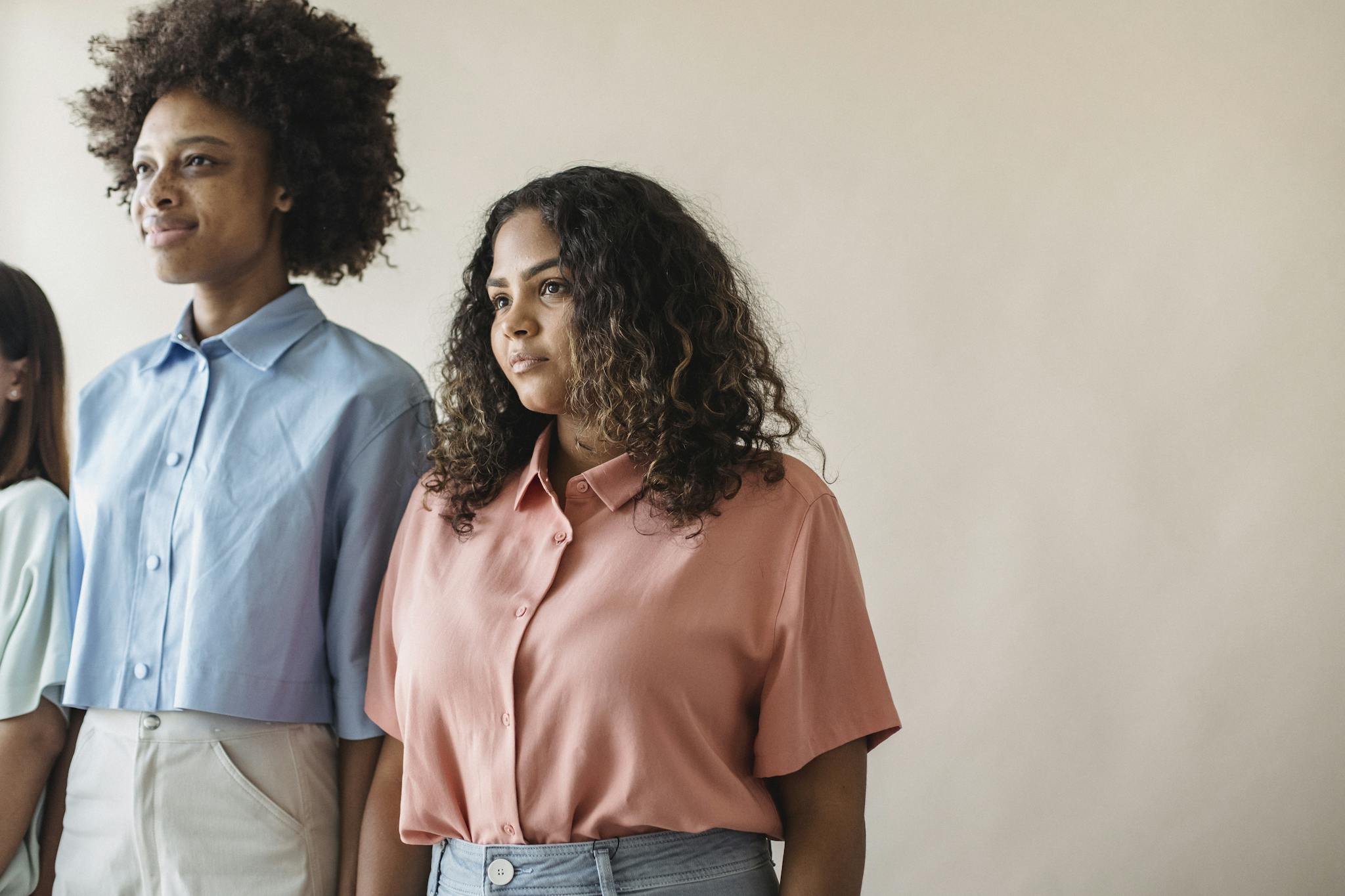 A diverse group of women standing proudly in stylish casual shirts, showcasing modern fashion.